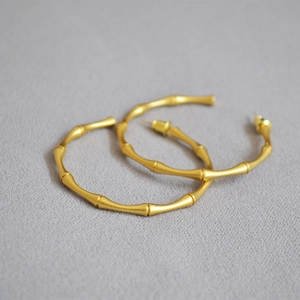 Elegant gold bamboo-joint C-shaped hoop earrings made of matte finish stainless steel