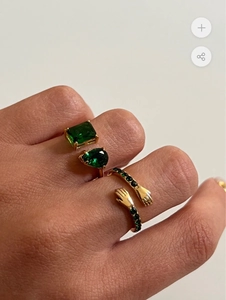 Macro-opname van 18k vergulde ringen met groene zirkonia en creatief handontwerp