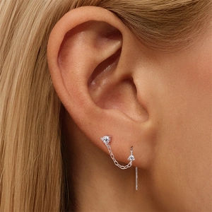 Detail of S925 sterling silver chain earring with round moissanite on model's ear
