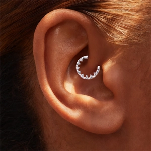 Close-up of S925 sterling silver moissanite daith piercing hoop worn on the ear