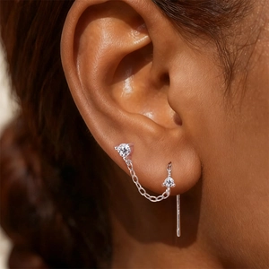 Macro shot of S925 sterling silver chain earrings with moissanite on ear lobe