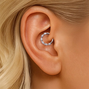 Macro shot of S925 sterling silver Daith piercing hoop with shimmering moissanite stones