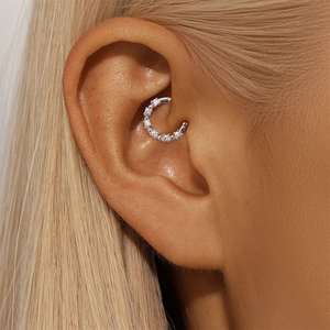 Close-up of S925 sterling silver piercing hoop with paved moissanite on ear cartilage