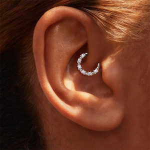 Macro shot of S925 sterling silver daith piercing ring set with sparkling moissanite stones