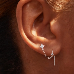 Detailed view of S925 sterling silver four-petal flower cartilage earring with tassels