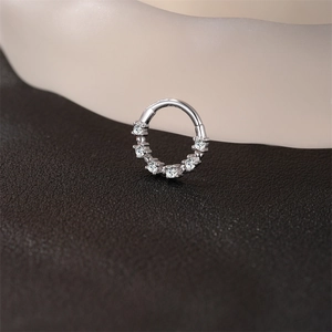 Macro shot of S925 sterling silver hinged hoop earring set with seven round moissanite stones