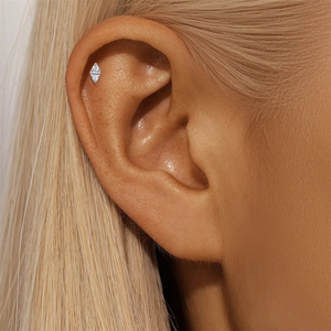 Close-up of S925 silver star bow piercing stud with marquise moissanite on ear