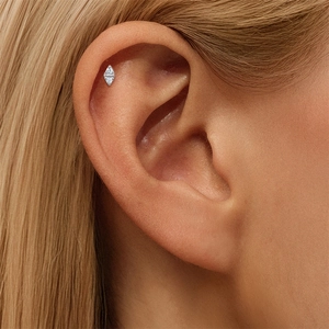 Detailed close-up of a S925 silver starburst stud earring with marquise moissanite stones