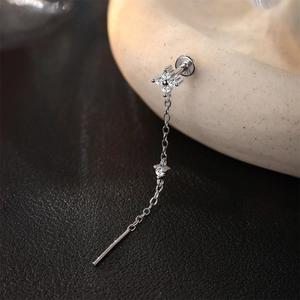 Macro detail of S925 sterling silver tassel earring with moissanite flower and 925 stamp