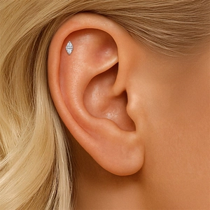 Close-up of S925 sterling silver star bow piercing stud with marquise moissanite on ear