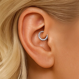 Close-up view of S925 sterling silver daith piercing ring with sparkling moissanite stones