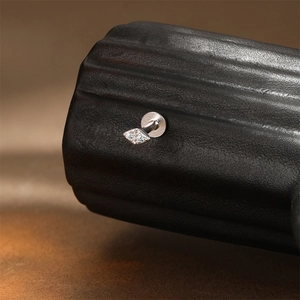 Macro shot of silver kite-shaped labret stud with inlaid marquise moissanite and flat back