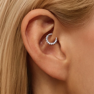 Macro shot of S925 sterling silver daith piercing ring set with sparkling moissanite stones