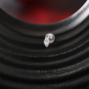Macro detail of S925 silver starburst piercing stud with dual moissanite stone inlay