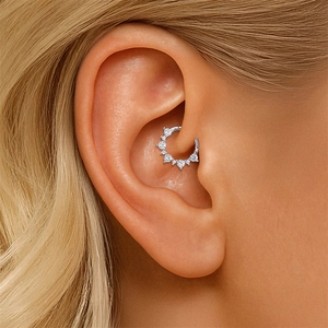 Macro view of S925 sterling silver moissanite hoop earring worn on the ear cartilage