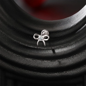 Macro shot of S925 sterling silver bow earring with a sparkling center moissanite stone