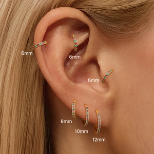 Macro shot of colorful zircon rainbow hoop earrings in sizes from 6mm to 12mm