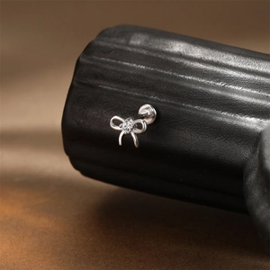 Macro shot of S925 sterling silver bow stud earring with sparkling cubic zirconia inlay