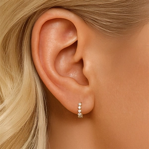 Close-up of gold S925 sterling silver hoop earring with four sparkling cubic zirconia stones