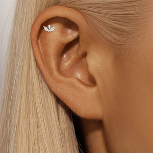 Detailed view of marquise-cut moissanite silver ear bone stud on a model's ear