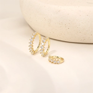Close-up of three gold S925 silver hoop earrings with cubic zirconia and hinge closure