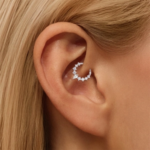 Detailed macro view of S925 sterling silver daith piercing with pear cut moissanite stone