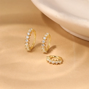 Macro shot of S925 sterling silver gold plated hoop earrings with zircon stones