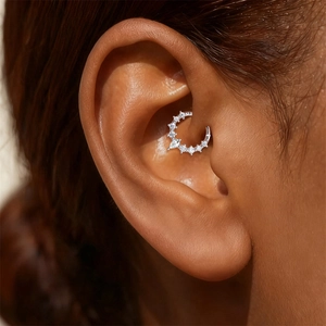 Macro shot of S925 sterling silver Daith piercing ring with pear-cut moissanite stone