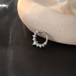 Macro shot of silver S925 sterling silver clicker hoop with pear-cut cubic zirconia inlay