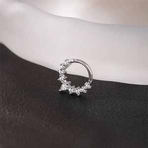 Macro shot of S925 silver nose ring featuring heart-shaped Moissanite and pavé stones