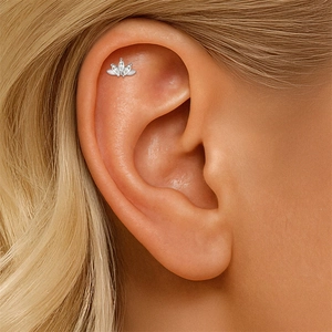 Detailed view of marquise-cut gems lotus ear stud on an actual ear piercing