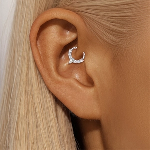 Macro shot of S925 silver daith piercing ring with sparkling marquise moissanite