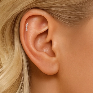 Close-up of gold flat back earring with marquise-cut crystals on conch piercing