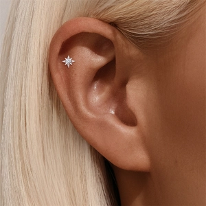 Close-up of S925 silver star cartilage stud earring with brilliant moissanite stone
