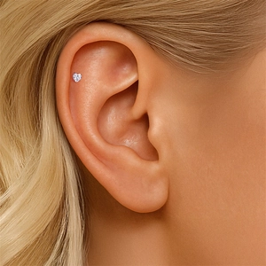 Close-up of heart-shaped S925 sterling silver stud earring with moissanite on ear cartilage