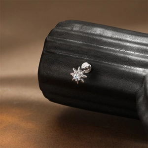Macro shot of S925 sterling silver star earring featuring a marquise moissanite stone