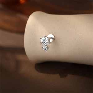 Macro shot of silver S925 stud with two round sparkling stones in 4-prong setting