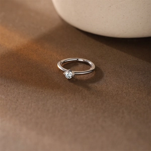 Macro shot of a classic s925 silver ring featuring a round brilliant-cut solitaire diamond
