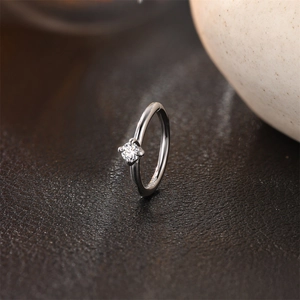Macro shot of S925 sterling silver stamp on minimalist ring with four-prong cubic zirconia