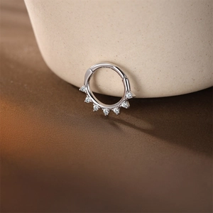 Macro shot of silver S925 sterling silver clicker ring with seven sparkling zircons