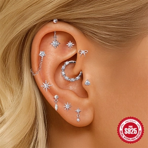 S925 Sterling Silver earring set with star and bow motifs on model's ear