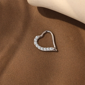 Detailed macro of S925 sterling silver heart cartilage hoop with moissanite pave setting