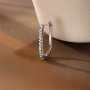 Macro detail of U-shaped S925 sterling silver hoop earring featuring row of moissanite stones