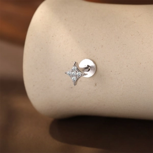 Macro shot of 925 sterling silver star labret earring with sparkling moissanite stones