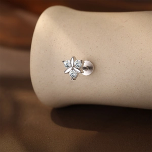 Detailed macro view of S925 sterling silver flower cartilage stud with moissanite inlay