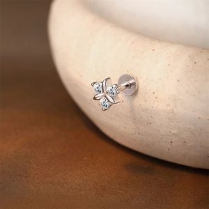 Macro shot of S925 sterling silver three-petal flower labret stud with brilliant crystals
