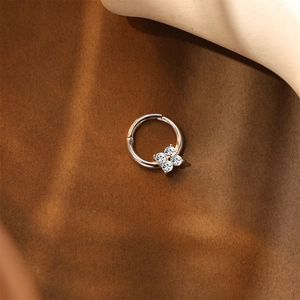 Close-up of rose gold S925 silver flower nose ring with sparkling zircon stones