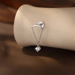 Macro view of S925 sterling silver cartilage earring with chain and moissanite stone