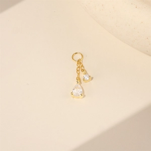 Detailed view of gold tassel earrings with teardrop and round cubic zirconia drops