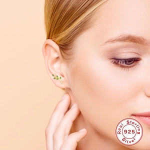 Minimalist S925 sterling silver olive branch earrings with green leaves on model